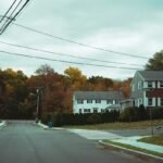 Residential street lined with houses and autumn trees in an American suburb